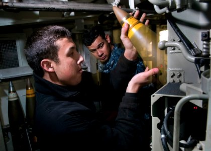 Flickr - Official U.S. Navy Imagery - Sailor loads MK-45 gun aboard USS Stockdale.