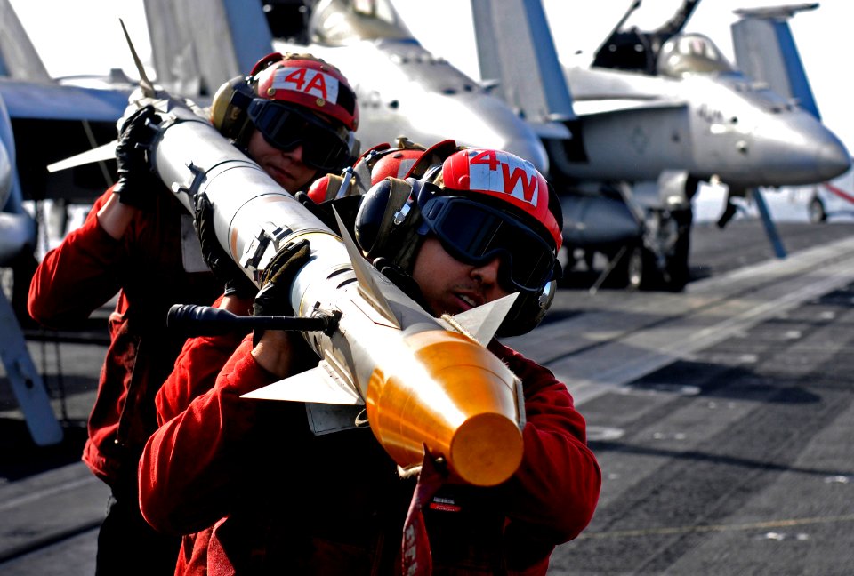 Flickr - Official U.S. Navy Imagery - Sailors carry an air-to-air missile from an F-A-18C Hornet after unloading ordnance. (1)