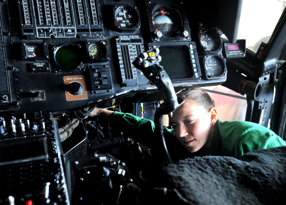 Flickr - Official U.S. Navy Imagery - Sailor installs tube in cockpit of Sea Hawk helicopter.