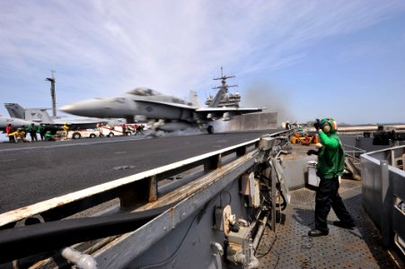 Flickr - Official U.S. Navy Imagery - Sailor operates catapults aboard USS Enterprise as jet takes off.