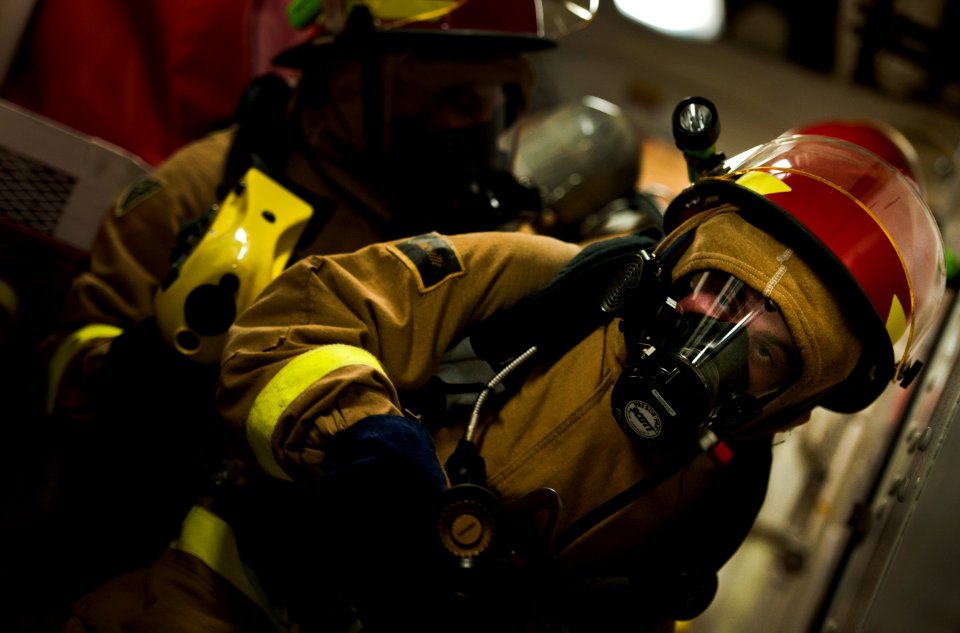 Flickr - Official U.S. Navy Imagery - Sailor moves through watertight door during firefighting drill.