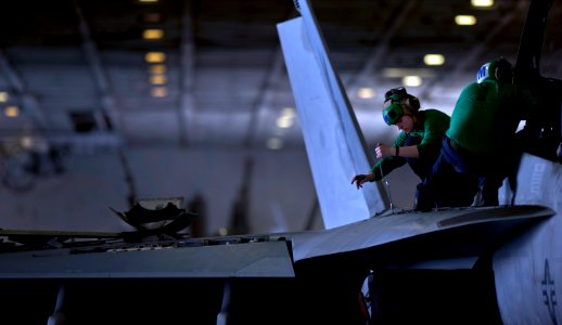Flickr - Official U.S. Navy Imagery - Sailor performs maintenance on Navy jet.
