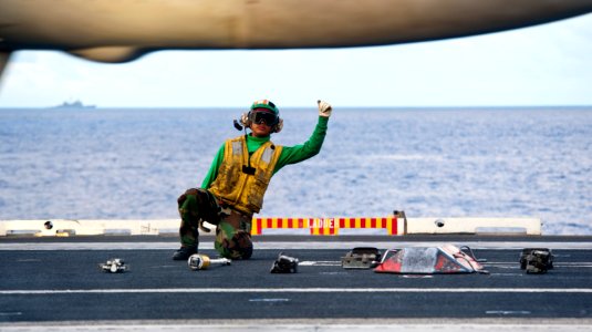 Flickr - Official U.S. Navy Imagery - Sailor signals for aircraft launch. photo