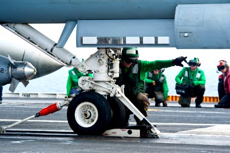 Flickr - Official U.S. Navy Imagery - Sailor prepares an F-A-18 for launch.