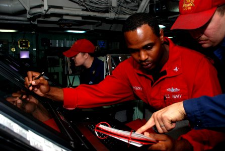Flickr - Official U.S. Navy Imagery - Sailors consult a manual during a drill.