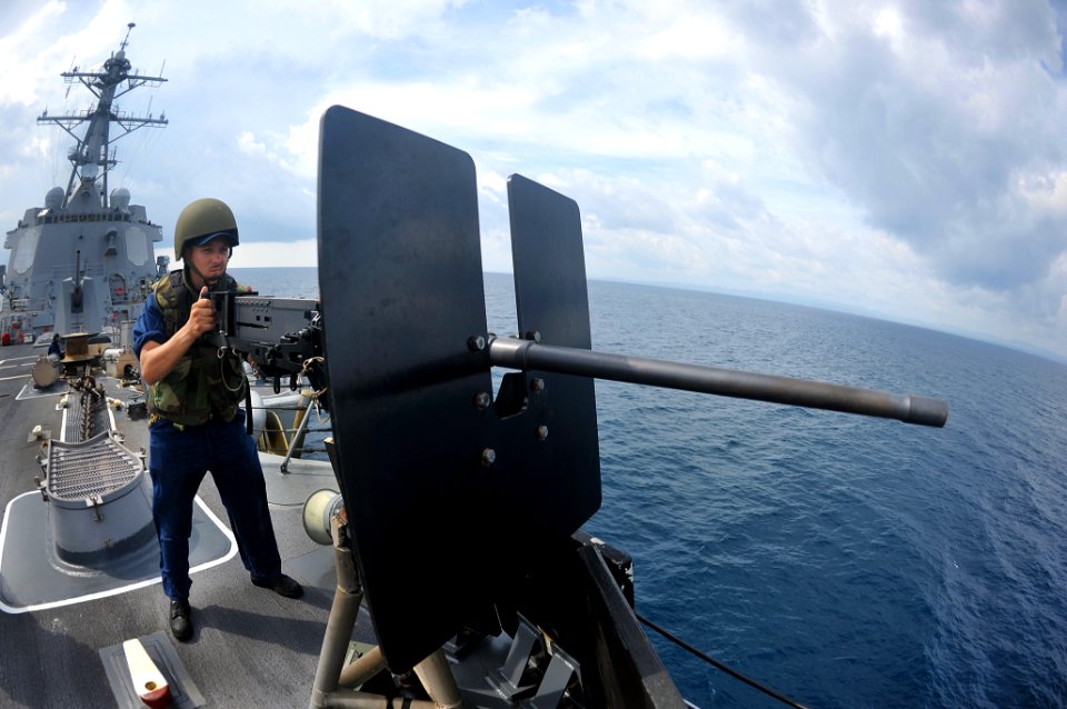 Flickr - Official U.S. Navy Imagery - Sailor stands at a .50-caliber machine gun.