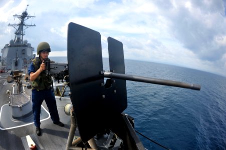 Flickr - Official U.S. Navy Imagery - Sailor stands at a .50-caliber machine gun.