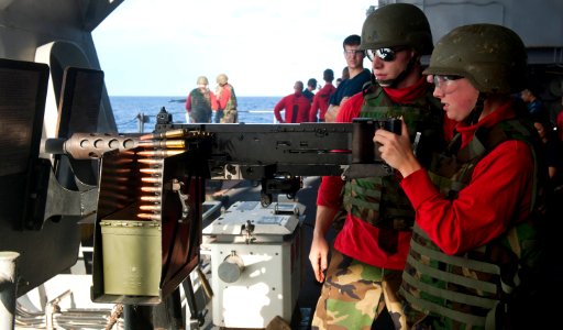 Flickr - Official U.S. Navy Imagery - Sailors fire a machine gun at sea.