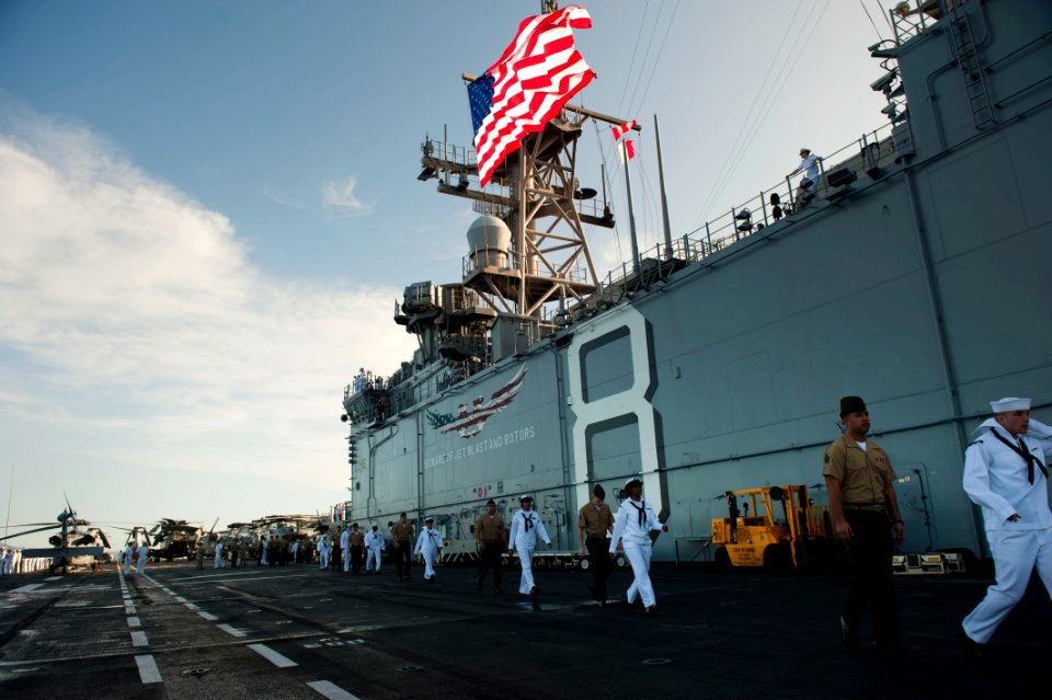 Flickr - Official U.S. Navy Imagery - Sailors and Marines walk on the flight deck of USS Makin Island as they prepare to man the rails.