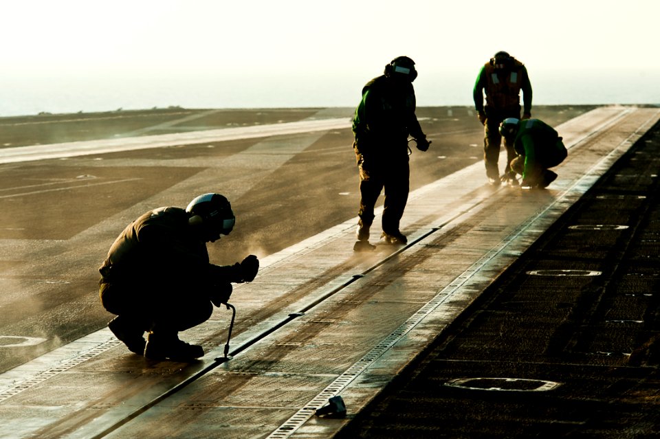 Flickr - Official U.S. Navy Imagery - Sailors install buttons into a steam-powered catapult aboard USS John C. Stennis (CVN 74).