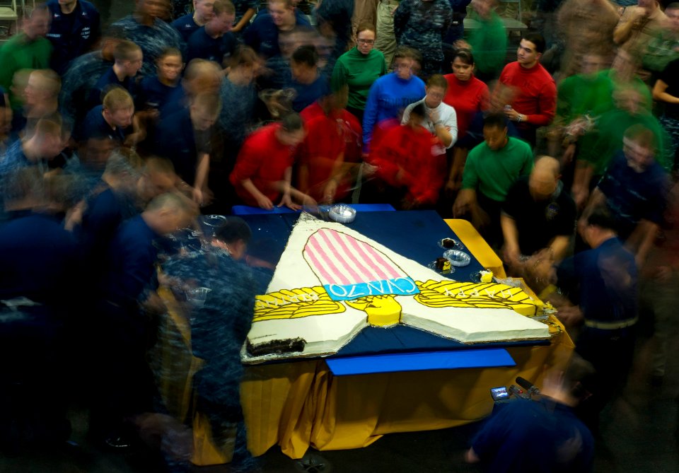 Flickr - Official U.S. Navy Imagery - Sailors line up for cake in the hangar bay.