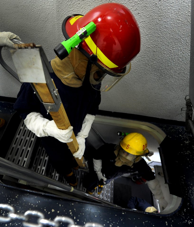 Flickr - Official U.S. Navy Imagery - Sailors carry shoring gear down stairs.