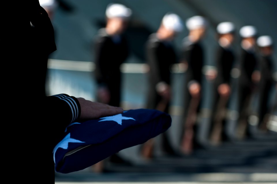 Flickr - Official U.S. Navy Imagery - Sailors bow their heads in prayer during a burial at sea