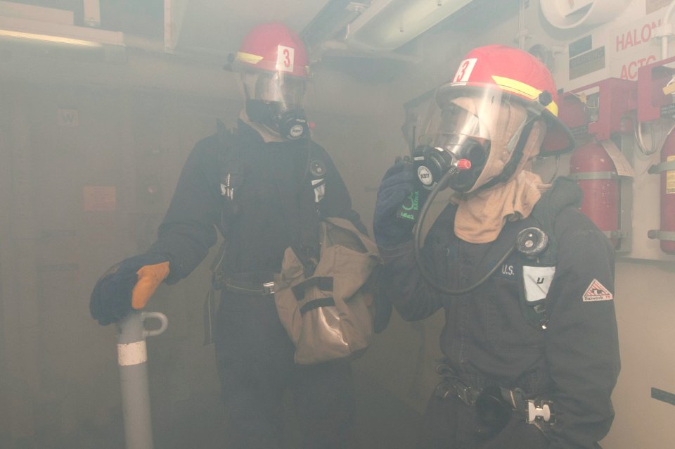 Flickr - Official U.S. Navy Imagery - Sailors check a smoke-filled space during a drill.
