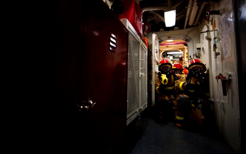 Flickr - Official U.S. Navy Imagery - Sailors move through quick-acting watertight door during drill.