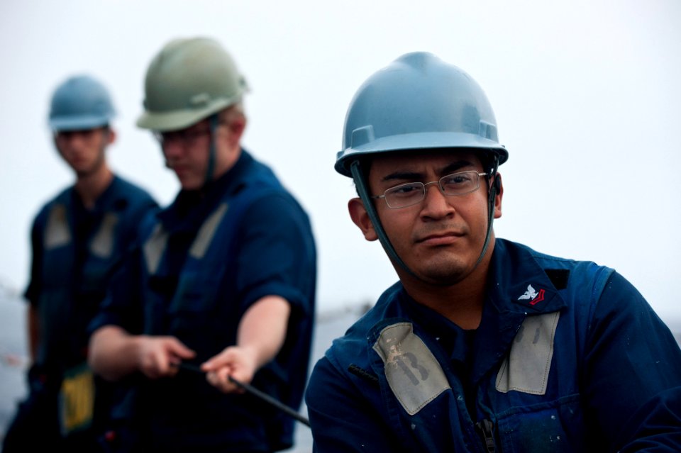 Flickr - Official U.S. Navy Imagery - Sailors heave on the phone and distance line during an early morning replenishment at sea.