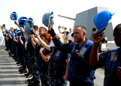 Flickr - Official U.S. Navy Imagery - Sailors raise their hard hats to USNS Rappahannock after completing a replenishment at sea.