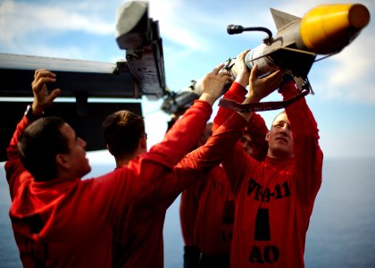 Flickr - Official U.S. Navy Imagery - Sailors remove a missile from an F-A-18F.