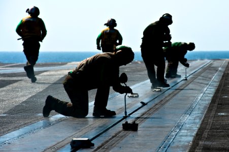 Flickr - Official U.S. Navy Imagery - Sailors install buttons into a steam-powered catapult slot aboard the aircraft carrier USS John C. Stennis (CVN 74).