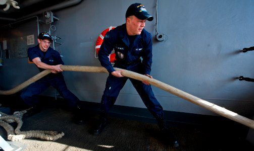 Flickr - Official U.S. Navy Imagery - Sailors heave mooring lines in the officer's brow.