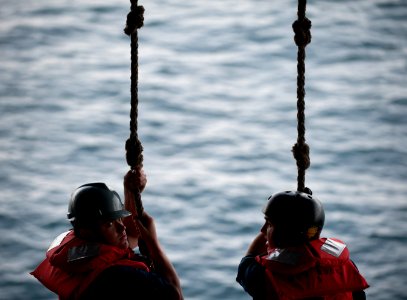 Flickr - Official U.S. Navy Imagery - Sailors hold monkey lines as they man a rigid-hull inflatable boat.