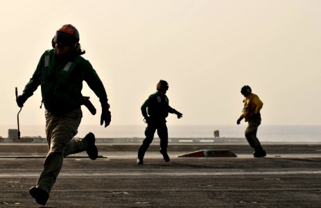 Flickr - Official U.S. Navy Imagery - Sailors run to clear the landing area after securing the waist catapults.