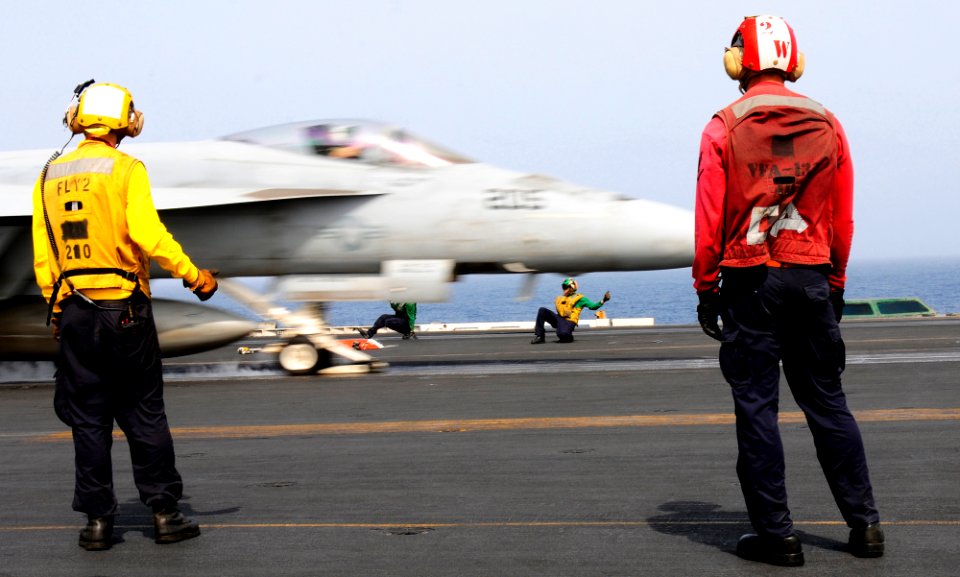 Flickr - Official U.S. Navy Imagery - Sailors observe as a jet launches from the flight deck.
