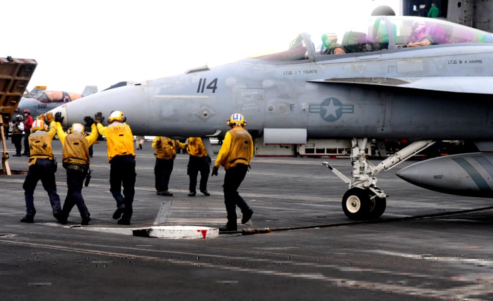 Flickr - Official U.S. Navy Imagery - Sailors position a jet on the flight deck.