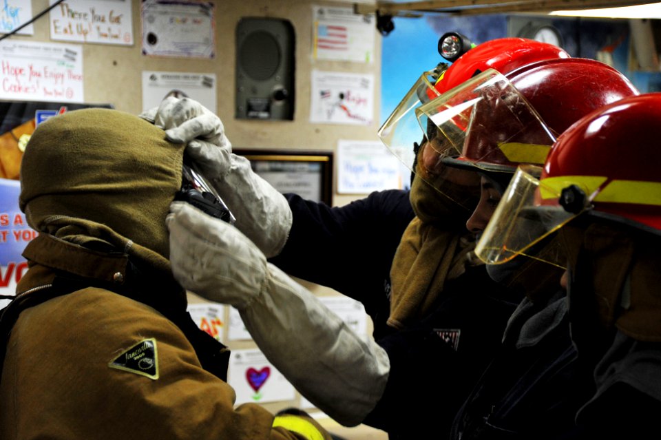 Flickr - Official U.S. Navy Imagery - Sailors put on firefighting gear.