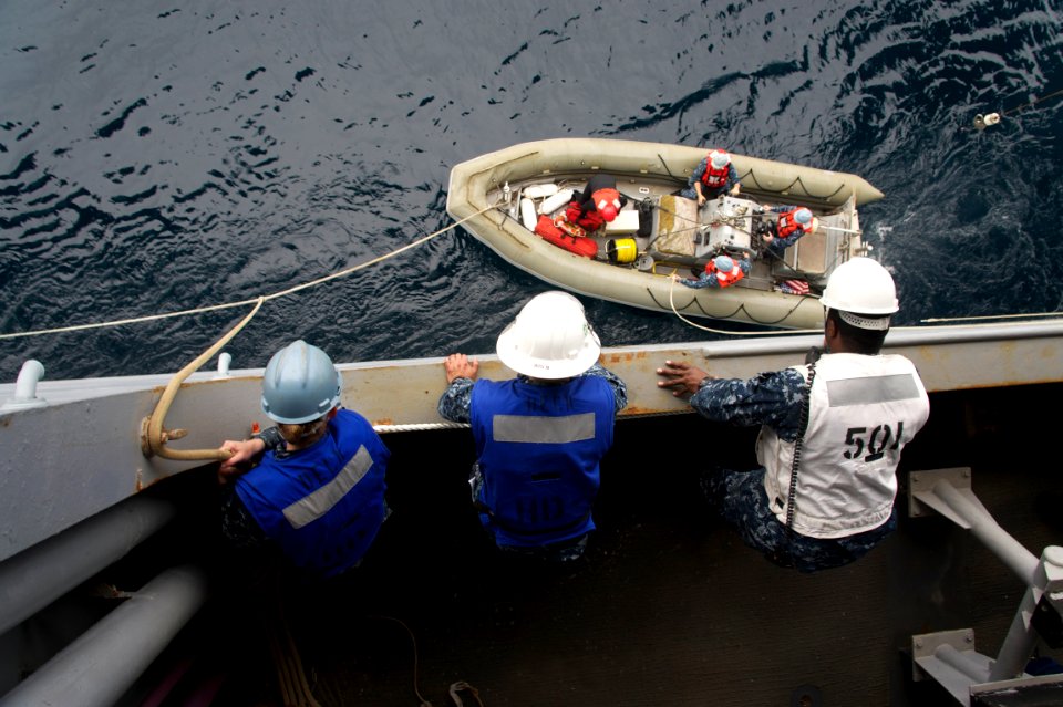 Flickr - Official U.S. Navy Imagery - Sailors retrieve a search and rescue boat during a man overboard drill.