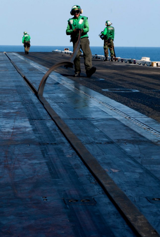 Flickr - Official U.S. Navy Imagery - Sailors remove a catapult seal from a catapult.