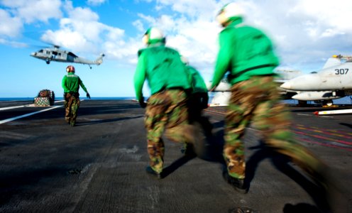 Flickr - Official U.S. Navy Imagery - Sailors run to move cargo on the flight deck during a vertical replenishment aboard the Nimitz-class aircraft carrier USS John C. Stennis.
