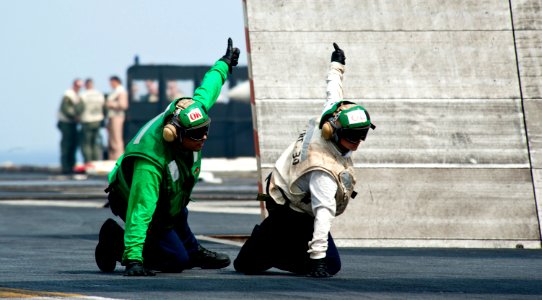 Flickr - Official U.S. Navy Imagery - Sailors signal for aircraft launch.
