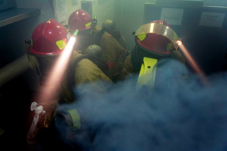 Flickr - Official U.S. Navy Imagery - Sailors simulate fighting a fire in a room filled with artificial smoke during a damage control drill.