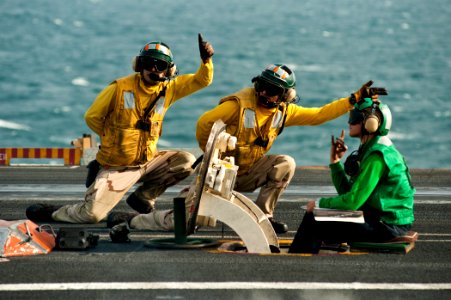 Flickr - Official U.S. Navy Imagery - Sailors signal the launch of an F-A-18F Super Hornet.