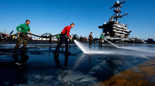 Flickr - Official U.S. Navy Imagery - Sailors spray the flight deck during a fresh water wash down.