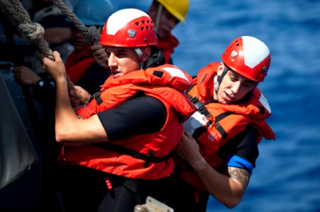 Flickr - Official U.S. Navy Imagery - Sailors work to lower a RHIB.