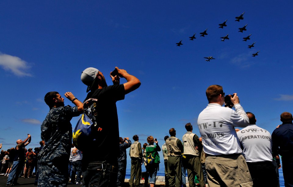 Flickr - Official U.S. Navy Imagery - Tiger cruise participants watch a formation of aircraft.