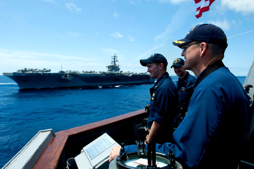 Flickr - Official U.S. Navy Imagery - The CO of USS Jason Dunham looks out as USS Dwight D. Eisenhower operates in the Atlantic Ocean.