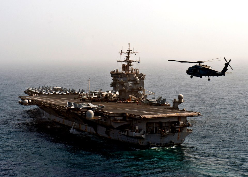 Flickr - Official U.S. Navy Imagery - The incoming CO of the Dragonslayers flies past USS Enterprise during an airborne change of command ceremony.
