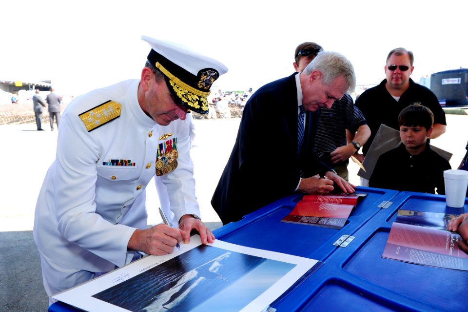 Flickr - Official U.S. Navy Imagery - The SECNAV and CNO sign photos before the commissioning ceremony for the Navy's ninth Virginia-class attack submarine USS Mississippi.