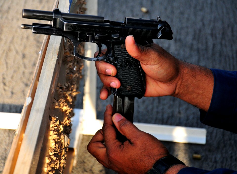 Flickr - Official U.S. Navy Imagery - USS Boxer Sailor reloads a 9mm pistol during weapons qualifications.
