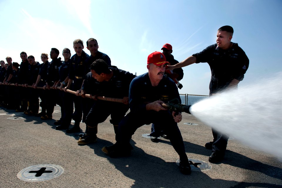 Flickr - Official U.S. Navy Imagery - The XO of USS Pearl Harbor operates the nozzle of a fire hose during damage control training.