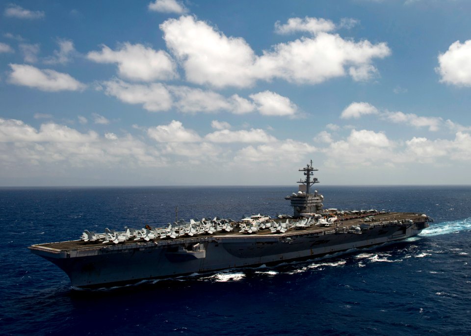 Flickr - Official U.S. Navy Imagery - Tiger cruise participants gather to commemorate their voyage with a spell-out on the flight deck.