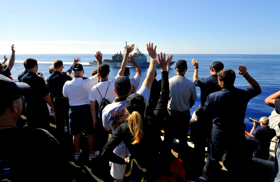Flickr - Official U.S. Navy Imagery - Tiger cruise participants wave to USS Bunker Hill as it pulls alongside.