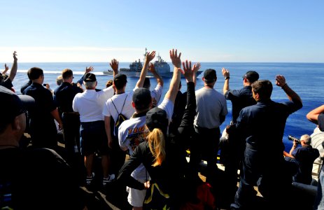 Flickr - Official U.S. Navy Imagery - Tiger cruise participants wave to USS Bunker Hill as it pulls alongside.