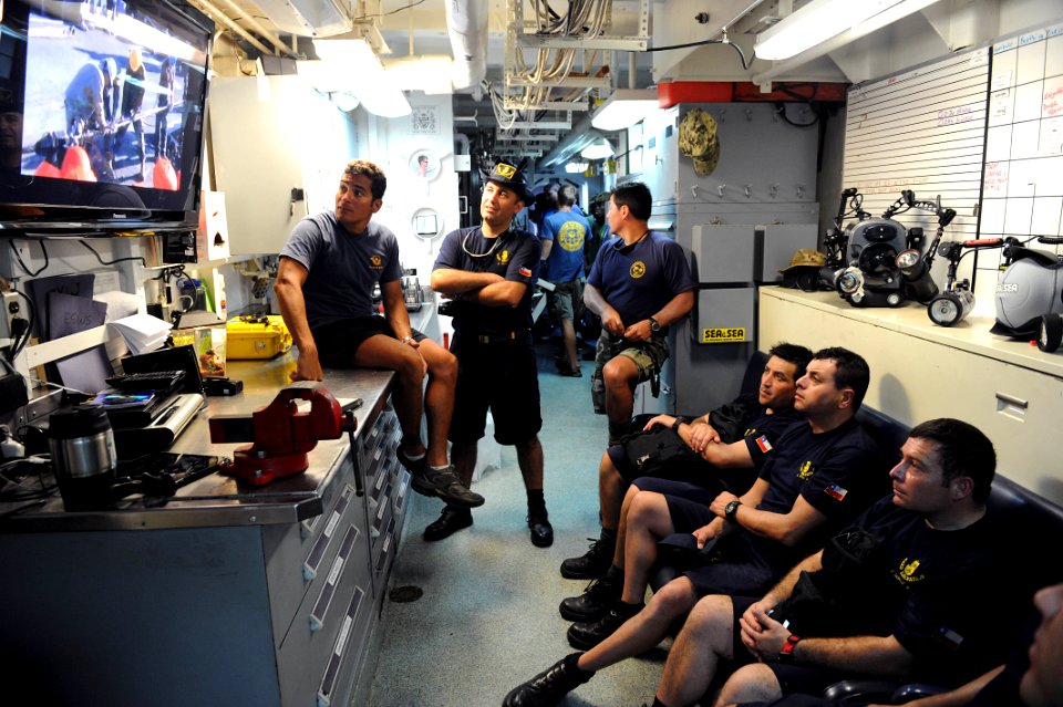 Flickr - Official U.S. Navy Imagery - U.S. Navy divers shows Chilean divers video of them de-beaching a ship earlier in the year.