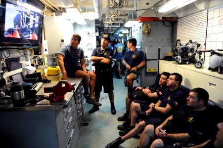 Flickr - Official U.S. Navy Imagery - U.S. Navy divers shows Chilean divers video of them de-beaching a ship earlier in the year.