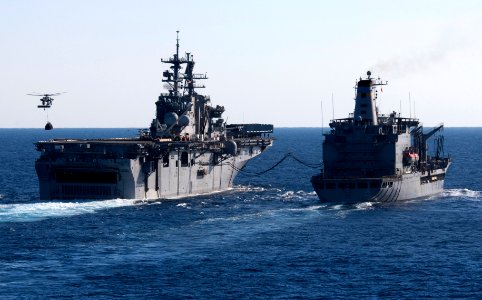 Flickr - Official U.S. Navy Imagery - USS Bataan receives fuel from USNS Laramie as MH-60 helicopter delivers supplies.