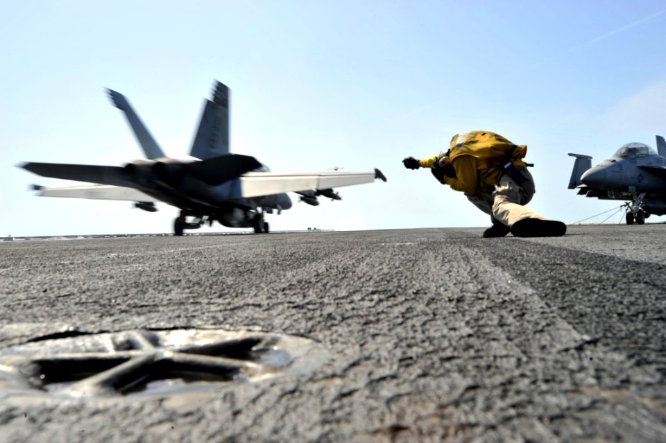 Flickr - Official U.S. Navy Imagery - USS Enterprise Sailor ducks after giving jet signal to launch.